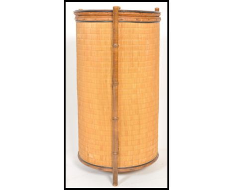 A 19th Century Victorian Aesthetic movement bamboo and wicker basket of cylindrical form having circular lid with finial top.