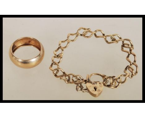 A hallmarked 9ct gold heart lock bracelet along with an unmarked 9ct gold band ring (tests as 9ct gold). Total weight 7.5g.