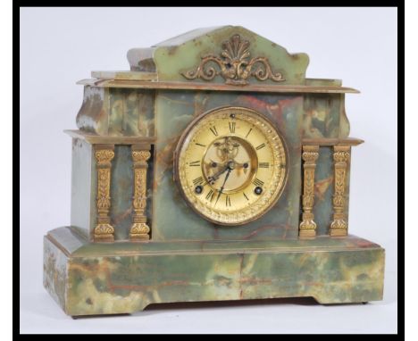 A Victorian 19th century green marble American Ansonia mantel clock having inset 8 day movement, gilded dial with roman numer