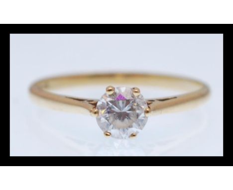 A hallmarked 9ct gold solitaire ring set with a brilliant cut white stone. Hallmarked Sheffield. Total weight 1.3g. Size M.5.