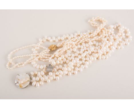 A triple entwined freshwater pearl necklace, silver gilt clasp, other freshwater pearl necklaces and a bangle. 