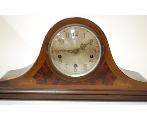 An Edwardian and mahogany and chequer strung mantel clock having silvered dial with Arabic numerals