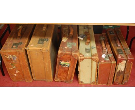An early 20th century leather clad travelling trunk together with five other leather and canvas clad examples (6)