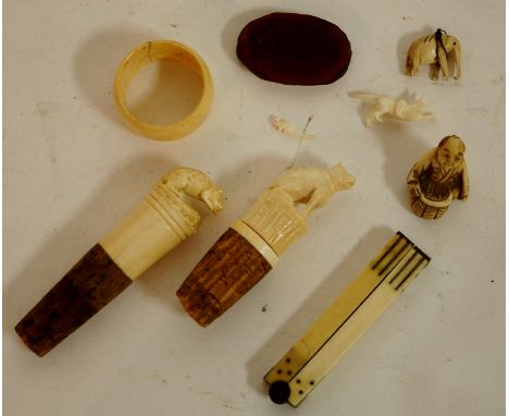 An early 20th century carved ivory bottle stopper surmounted by a rat together with one other similar, carved bone netsuke et