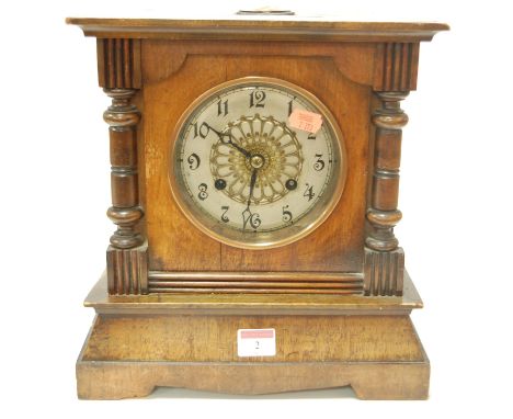 A late 19th century Continental walnut cased mantel clock having silvered dial with Arabic numerals and eight day movement st