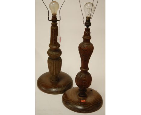 A carved oak table lamp base together with one other (2)