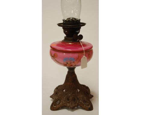 A circa 1900 pedestal oil lamp having pink glass reservoir with hand painted decoration