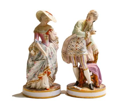 A large pair of French porcelain figures of a lady and gentleman, late 19th century, in formal attire and each raised on a ci