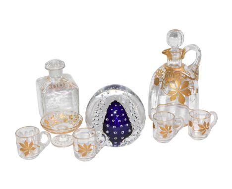 Six coloured glass scent bottles with gilt and enamel decorations, a glass paperweight, a gilt decorated liqueur decanter and