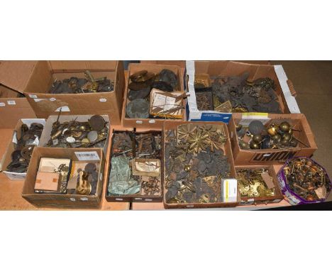 A quantity of clock makers parts, including: various clock case metal mounts, longcase clock pulleys, mantel clock pendulums,