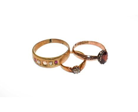 A 9 carat gold garnet ring, finger size M1/2; a diamond solitaire ring, stamped '18', finger size C; and a diamond and synthe