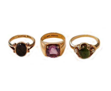 A 9 carat gold onyx intaglio ring, finger size K; a 9 carat gold amethyst ring, finger size H1/2; and another ring, indistinc