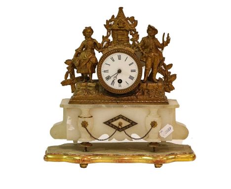 A late 19th century gilt metal and alabaster timepiece, the enamelled dial with a drum case surmounted by a cottage flanked b