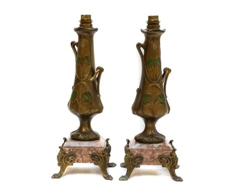 A pair of secessionist gilt metal lamp bases raised on marble plinths, 34cm high (2)Condition report: Both would need to be r