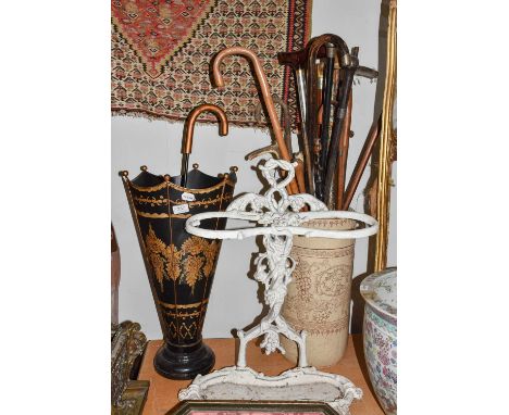 ~A Victorian Coalbrookdale style painted cast iron stick stand, 61cm high, together with a Toleware stick stand formed as an 