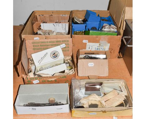 A selection of watch and clock makers parts, including: enamel pocket watch dials, one depicting a locomotive, two mystery cl