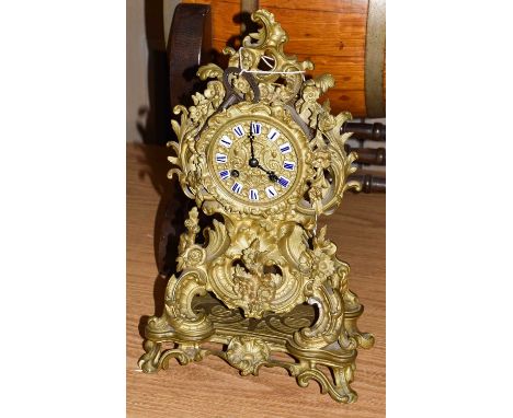 A 19th century French gilt metal striking mantel clock of Neo-Rococo form, with enamel Roman numeral markers, striking on a b