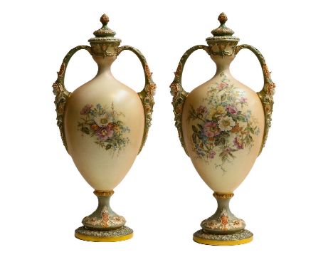 A large Royal Worcester blush ware twin-handled urn and cover, moulded with masks and painted with a loose bouquet of wild fl