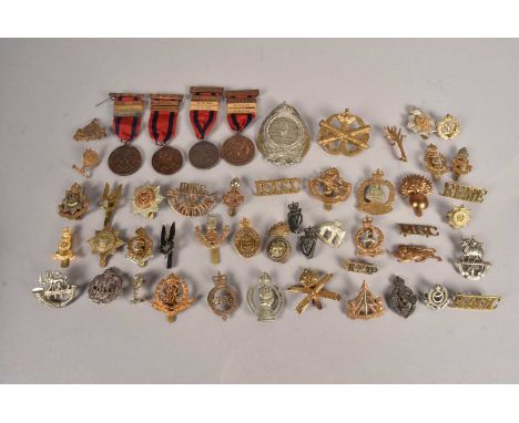 A collection of British Cap badges, including RASC, RAOC, RAF, Kings Dragoon Guards, Reconnaissance Corps, Royal Army Medical