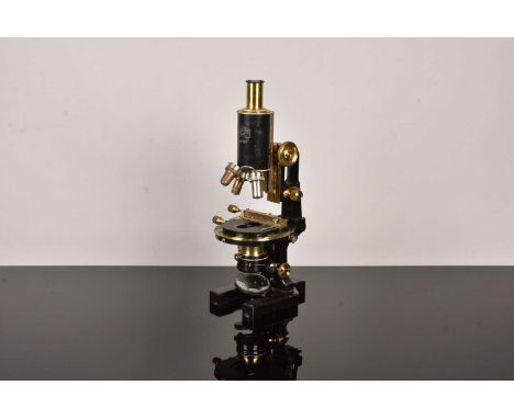 An early 20th Century black painted and lacquered brass Carl Zeiss Compound Monocular Microscope, serial 49767, with jug hand