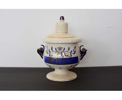 A Royal Pharmaceutical Society ceramic Pharmacists Apothecary Jar and Cover, for 'Honey', cream ground, with blue decoration,
