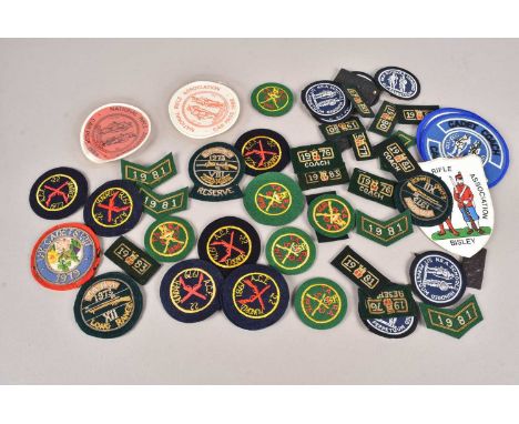 An assortment of Rifle Association related cloth and bullion badges, 1970s and 1980s, various designs, with duplication (parc