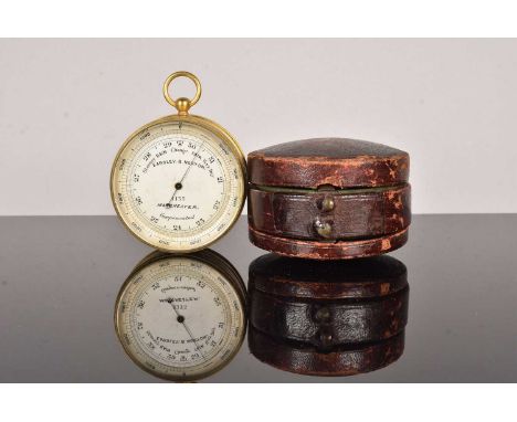 An Eardley B Norton gilt brass aneroid pocket barometer with altimeter scale and compass, a late 19th century example with ci