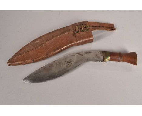 An Indian Kukri Knife, having 'Hituman Gurkha, Darjeeling' stamped to the brass pommel, with one piece wooden handle, having 