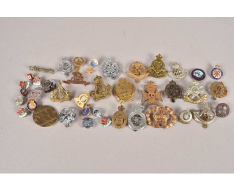 An assortment of Military badges, to include Canadian Ordnance Corps, Women's Transport Services, Durham Light Infantry, King