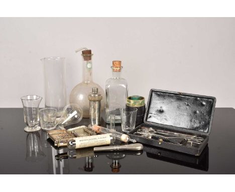 An assortment of Medical Instruments and Glassware, including Dr Bengue's Anaesthetic Chlorethyl bottle in box, a cased Medic