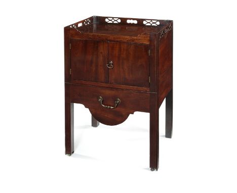 A George III mahogany tray top commode
The rectangular top with a pierced fret carved gallery also pierced with carrying hand