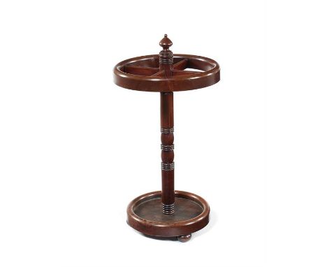 A George IV mahogany stick/cue standThe circular pierced four division top, on a ring turned column with circular drip pan be