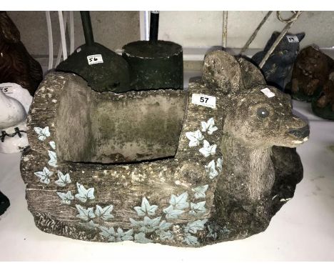 A concrete planter with deer feature