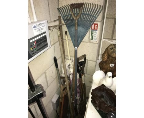 A quantity of garden tools including forks and rakes etc.