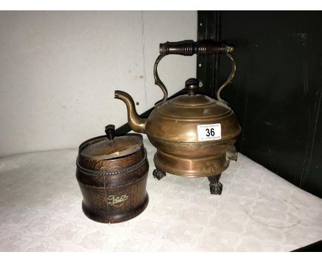 A vintage copper electric kettle on ball and claw feet and an oak tea caddy