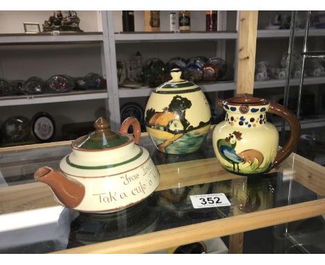 A Torquay ware puzzle jug, teapot and a storage jar