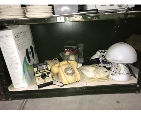 A shelf of vintage telephone, camera and other electrical items