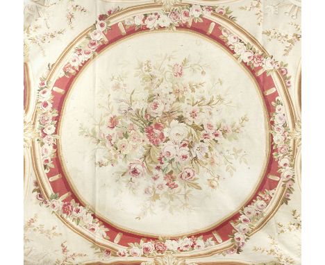 A large Aubusson carpetearly 20th century, Francewith large central flower-filled roundel, each corner bearing elaborate foli