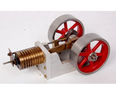 Scratch built flame licker type engine having single cylinder driving crankshaft with heavy 2¼ inch flywheels at each end and