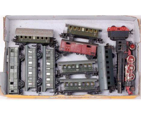 A Marklin H0 1950s 2-6-2 engine and tender good for age (G) and 8 green four wheel coaches and a goods van (F-G)