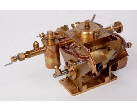 Finely engineered from brass, marine type engine with 4 oscillating cylinders paired at 90 degrees to drive a heavy pierced f
