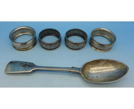 Four silver napkin rings and a silver spoon, 80g