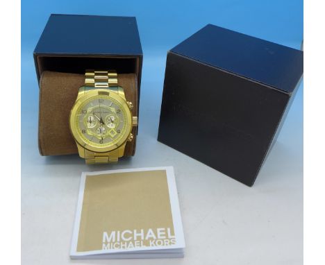 A gentleman's Michael Kors Gold Tone chronograph wristwatch with box and manual