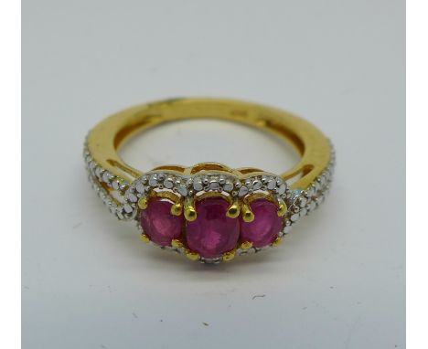 A silver gilt and ruby trilogy ring, M
