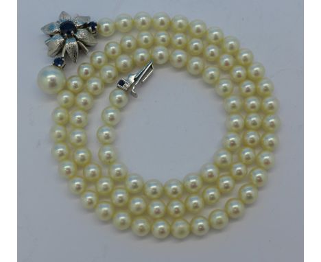 A pearl necklace with 18ct white gold and sapphire clasp