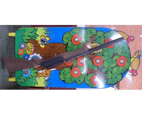 A Mettoy Playcraft toy rifle and tin plate target with revolving birds