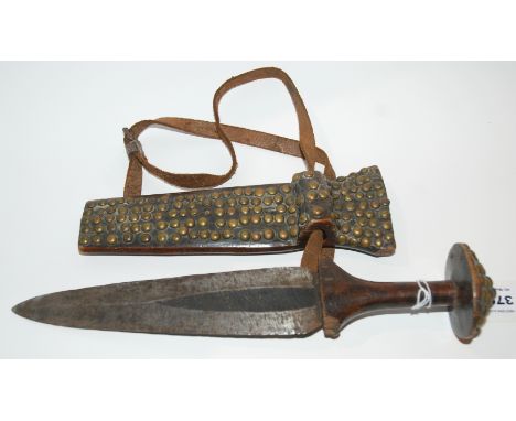 An tribal African dagger with studded scabbard Condition Report: Available upon request