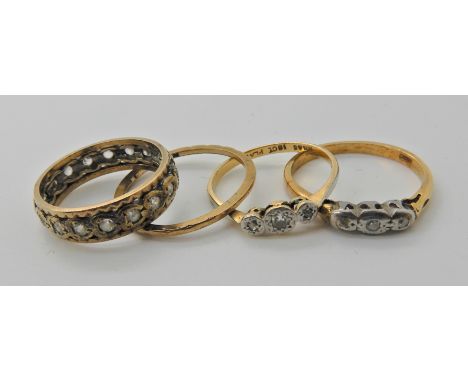 two 18ct gold three stone diamond rings sizes R and N, weight together 4.2gms, a 9ct wedding band (worn thin) and a 9ct gold 