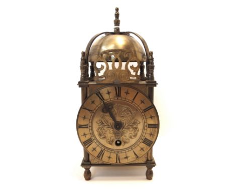 A brass lantern eight day clock (winds but not ticking, hour hand loose) Condition Report: Available upon request