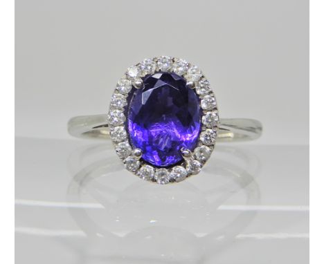 A platinum tanzanite and diamond cluster ring, head size 11.6mm  x 10mm, tanzanite come with an anchor certificate stating it